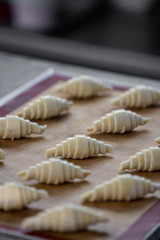 Raw croissants preparation for with raw egg painted on top process before baking /baking concept / copy space