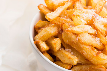 Bowl of potatoe fries on a white background