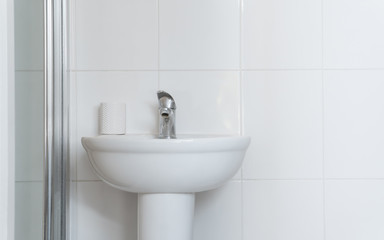 White wash basin in the white bathroom in classic and standard decoration.