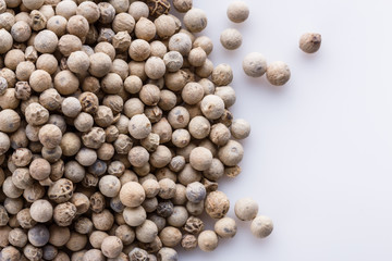 white peppercorns seed on white acrylic background