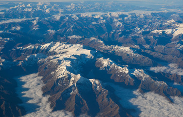 Aerial view above the clouds at mountain peaks