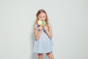 little girl eating sweet candy lollipop on a stick