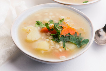 Barley soup, pearl barley in white bowl