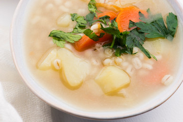 Barley soup, pearl barley in white bowl