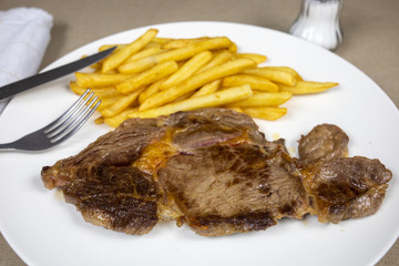 grilled beef steak and fries on a plate