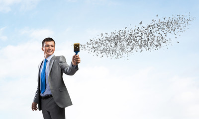 Creative businessman painter holding paintbrush