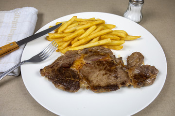 grilled beef steak and fries on a plate