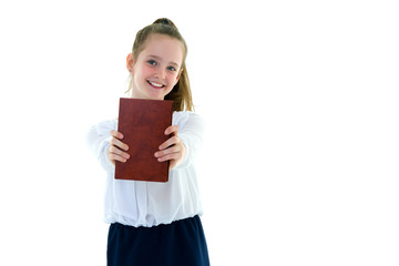 Cute little girl with a book in her hands, the concept of litera