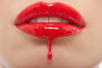 Red Lipgloss Dripping From Woman's Lips