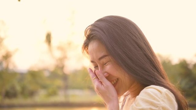 Slow motion,A portrait of  asian woman smiling brightly in park