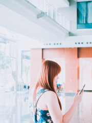 woman power and business owner concept from beauty asian girl during use mobile phone call to her customer in modern office with happiness feeling