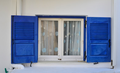 Traditional blue windows over white walls