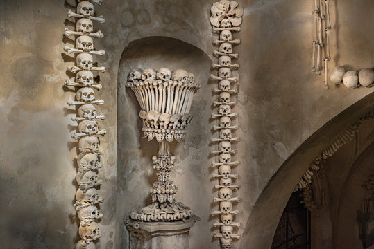 Prague, Czech Republic - Sept 04, 2019: Arranged Human Skulls and Bones in Kostnice Church in Kutna Hora, Czech Republic. Ossuary decoration of human bones and skulls