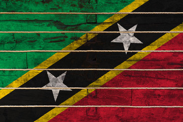 National flag  of Saint Kitts and Nevis. on a wooden wall background. The concept of national pride...