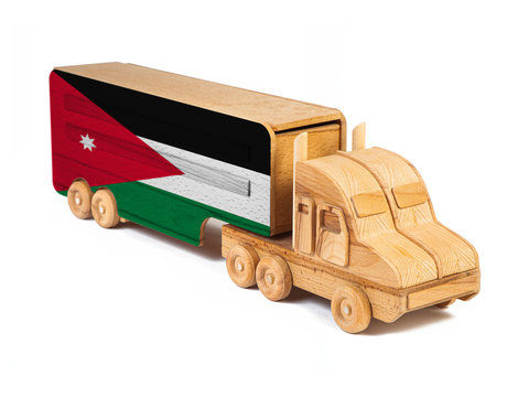 Close-up of a wooden toy truck with a painted national flag Jordan. The concept of export-import,transportation, national delivery of goods