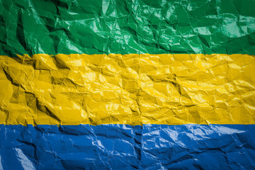 National flag of Gabon on crumpled paper. Flag printed on a sheet. Flag image for design on flyers,...
