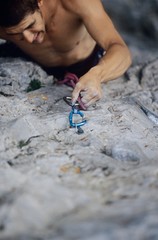 Rock Climber Struggling On Cliff