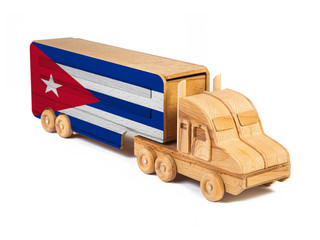 Close-up of a wooden toy truck with a painted national flag Cuba. The concept of export-import,transportation, national delivery of goods