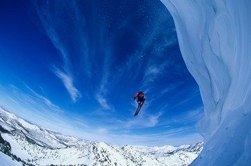 Man Jumping From Mountain Ledge