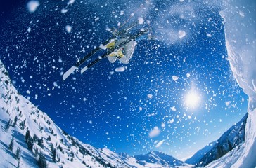 Skier Jumping From Mountain Ledge