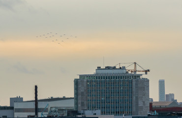 Malmo - Sweden December 16 2019:Swedish fighter jet Saab 39 Gripen or JAS 39A/B/C/D Gripen, flies Christmas tree formation over Malmo port.
