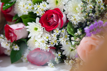 Red roses and colorful flowers, symbols for love and congratulations