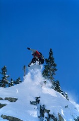 Naklejka na ściany i meble Snowboarder Jumping From Mountain Ledge