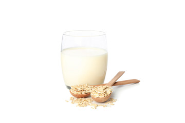 Oat milk and oatmeels in spoon isolated on white background