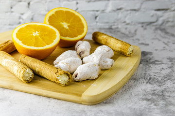 homemade confection and orange on wooden board