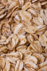 raw oat flakes on white acrylic background