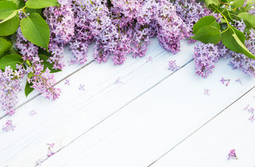 Bouquet of purple lilacs flowers on a light blue shabby wooden background. Vintage floral...