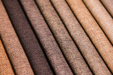 Colorful and bright fabric samples of furniture and clothing upholstery. Close-up of a palette of...