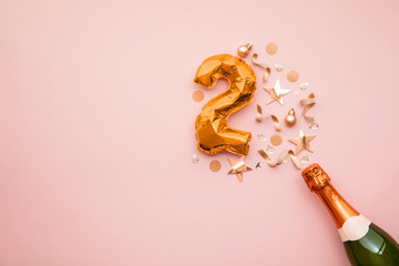 Happy 2nd anniversary party. Champagne bottle with gold number balloon.