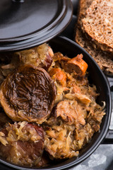 Traditional polish sauerkraut (bigos) with mushrooms and plums for christmas