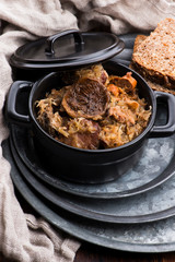 Traditional polish sauerkraut (bigos) with mushrooms and plums for christmas