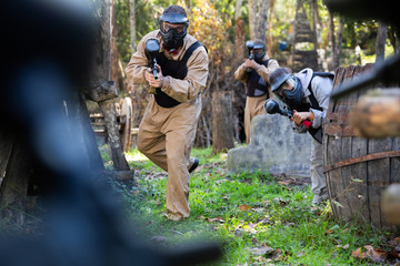 Fototapeta premium People playing paintball outdoors