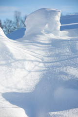 Snowdrift of the original form on a fine winter day. Close-up. Selective focus