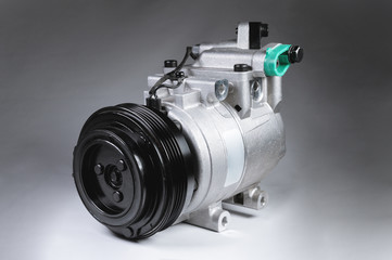 Close-up New car air conditioning compressor on grey background