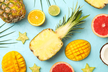 Composition with exotic fruits on blue background, top view