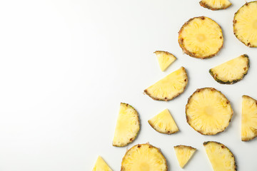 Flat lay with pineapple slices on white background, space for text