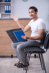 Young man at hospital reception desk