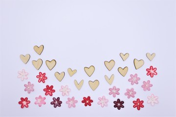Valentines Day or wedding lovely concept wooden hearts with colorful paper flower background