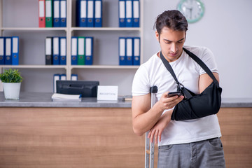 Young man at hospital reception desk