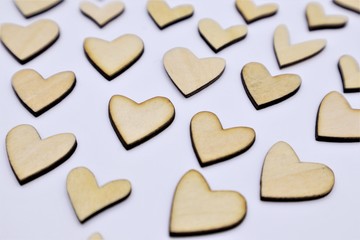 Valentines Day or wedding lovely concept wooden hearts with colorful paper flower background