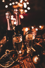 New Year’s Eve celebration with bottles and glasses of champagne. Masquerade themed party....