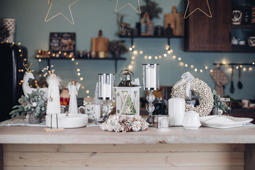 Close-up table with Christmas fairytale decoration amazing flashing garland holiday mood. Modern room with different New Year interior decoration ready celebrating december winter greetings front view