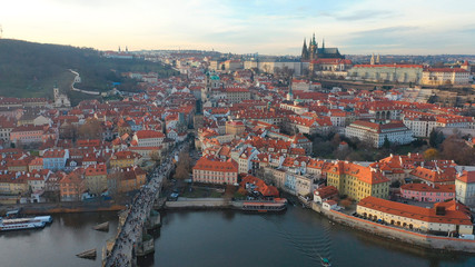Aerial view of Charles Bridge and Prague Castle at sunset light in desember in Prague, Czech Republic