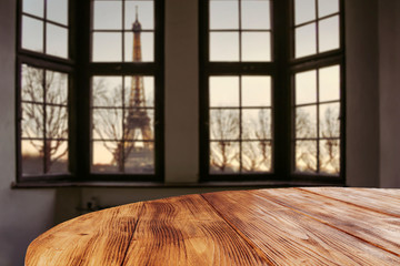 Dark wooden table of free space and window sill background with city landscape. 