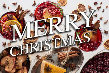 top view of christmas cocktails with orange, pomegranate, cinnamon, pie on tray, dry apples and frozen cranberry with merry Christmas and happy new year illustration