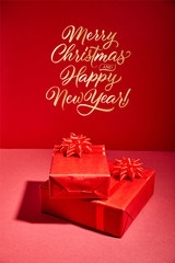 red Christmas gift boxes on red background with golden Merry Christmas and happy new year illustration